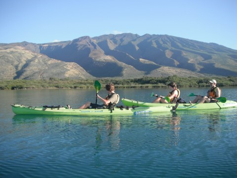 a group of people on a boat in the water