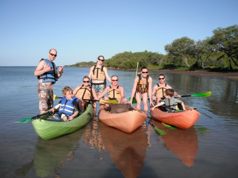 a group of people in a boat on a body of water