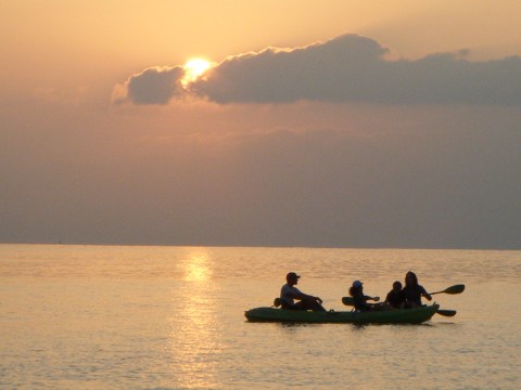 a group of people in a boat on a body of water