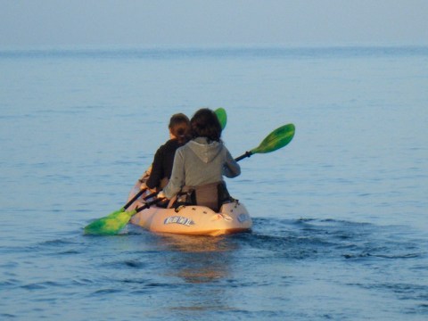 a person riding a surf board on a body of water