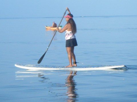 a person riding a surf board on a body of water