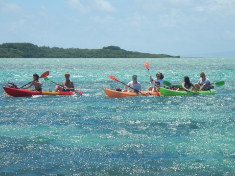 a group of people in a boat on a body of water