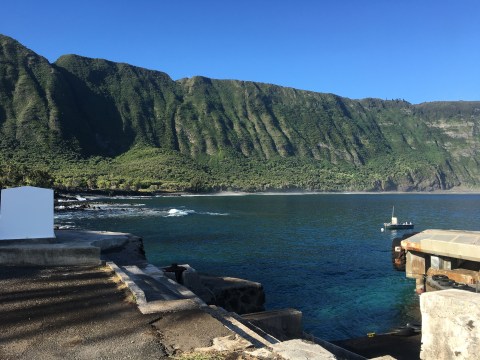 a body of water with a mountain in the background