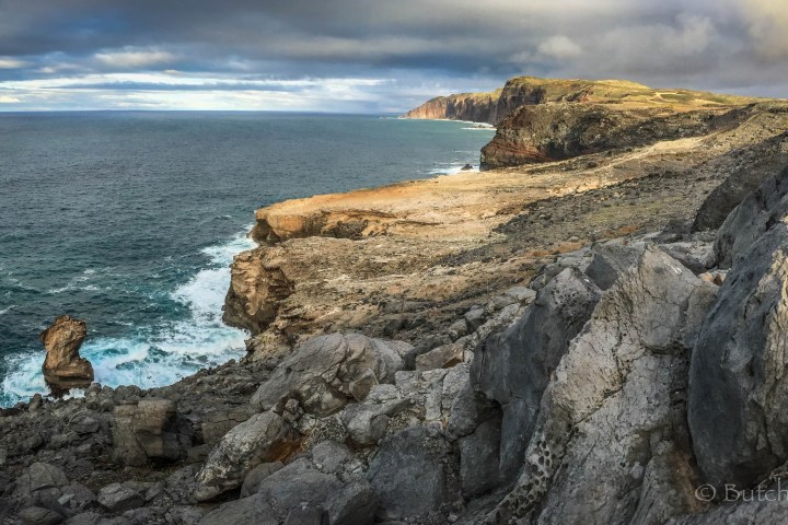 a rocky beach next to the ocean