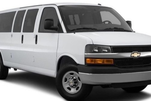 a van parked in front of a car