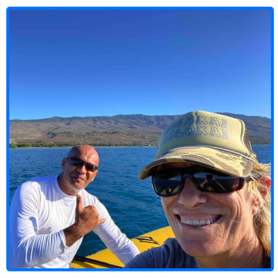 a man wearing a hat and smiling at the camera