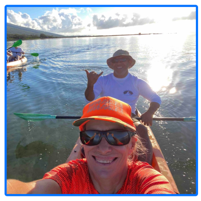 a man standing next to a body of water